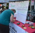 Resident providing feedback at an Outreach Booth at the Downtown Farmers' Market