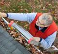 Man cleaning gutters