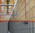 egan gym looking at a basketball hoop through a volleyball net