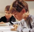 Two children reading their book