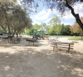 Sideview of Grant Park that includes a picnic table and child's playground