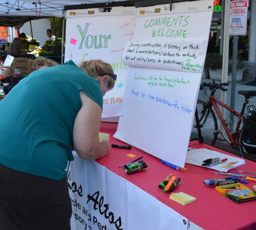 Resident providing feedback at an Outreach Booth at the Downtown Farmers' Market