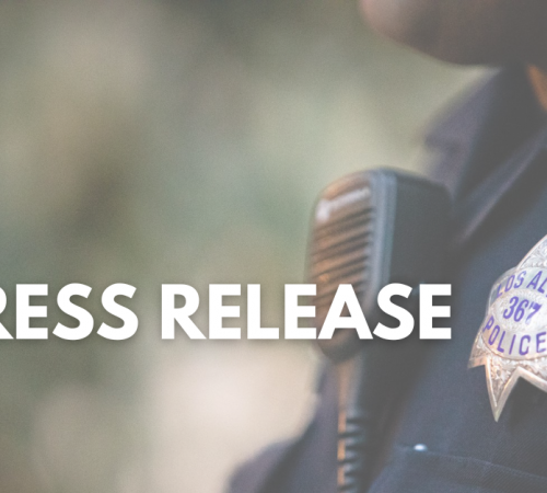 Words 'Press Release' in front of an officer's badge and radio