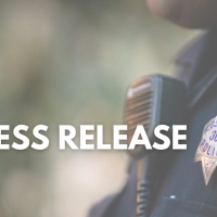 Words 'Press Release' in front of an officer's badge and radio