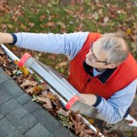 Man cleaning gutters