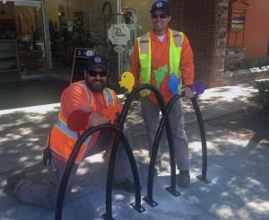 Public Works staff installing artistic bike racks
