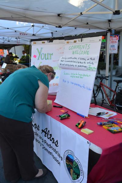 Resident providing feedback at an Outreach Booth at the Downtown Farmers' Market