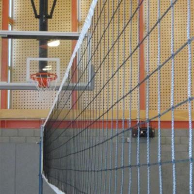 egan gym looking at a basketball hoop through a volleyball net