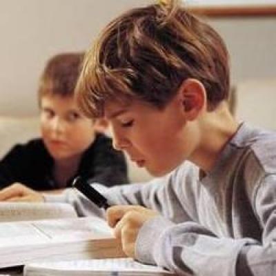 Two children reading their book