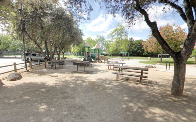 Sideview of Grant Park that includes a picnic table and child's playground