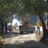 Four workers paving out part of Homestead Road.