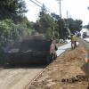 Workers adding pavement to a sidewalk.